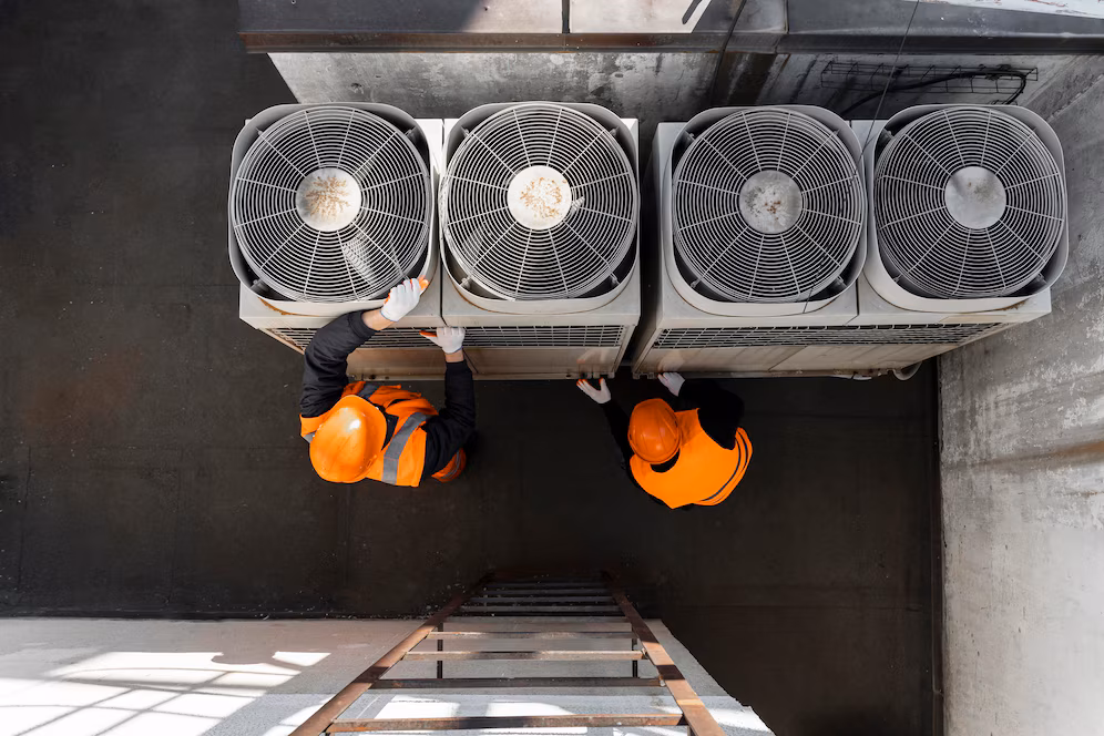 ACR technicians servicing commercial HVAC equipment in Caledonia MI